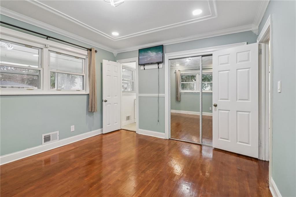 716 Carolina Road Marietta, GA 30008 - Photo 39 of 71 an empty room with wooden floor and windows