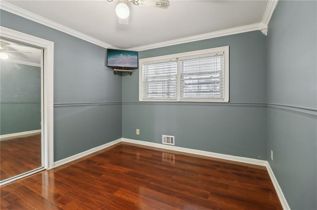 716 Carolina Road Marietta, GA 30008 - Photo 45 of 71 an empty room with wooden floor and windows
