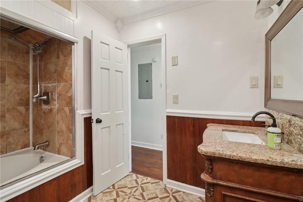 716 Carolina Road Marietta, GA 30008 - Photo 50 of 71 a bathroom with a granite countertop sink a mirror and a bathtub