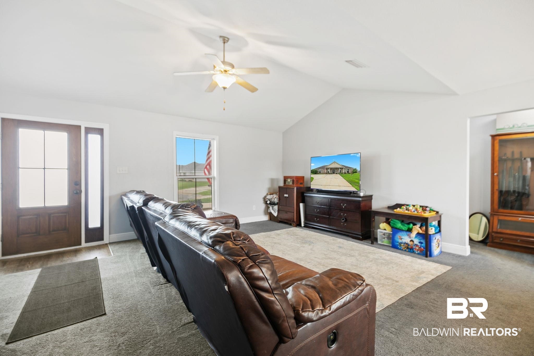 15573 Talus Court Foley, AL 36535 - Photo 11 of 50 Carpeted living room featuring vaulted ceiling and ceiling fan