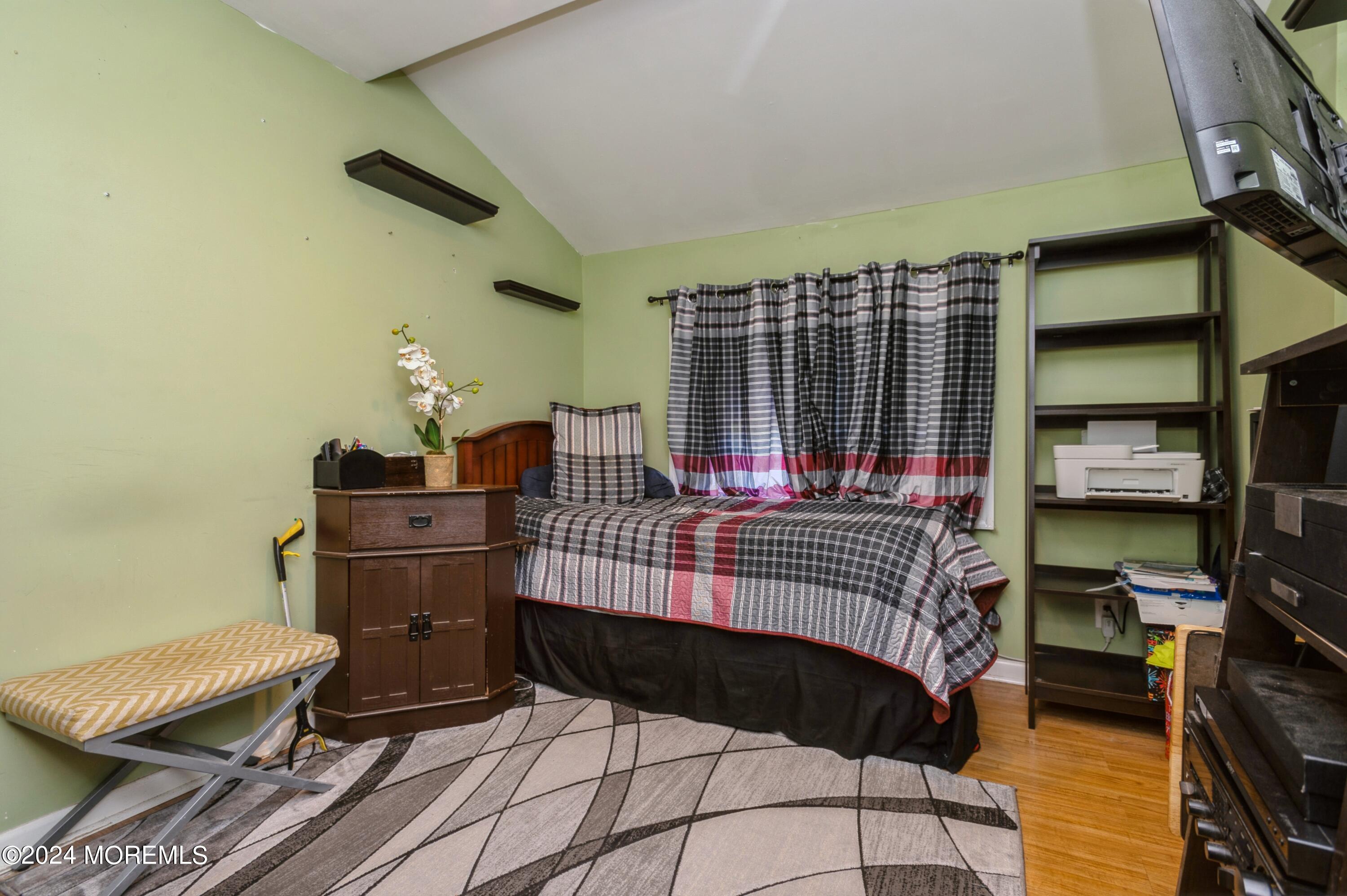62 Capri Drive Brick, NJ 08723 - Photo 12 of 22 a bedroom with a bed and a book shelf