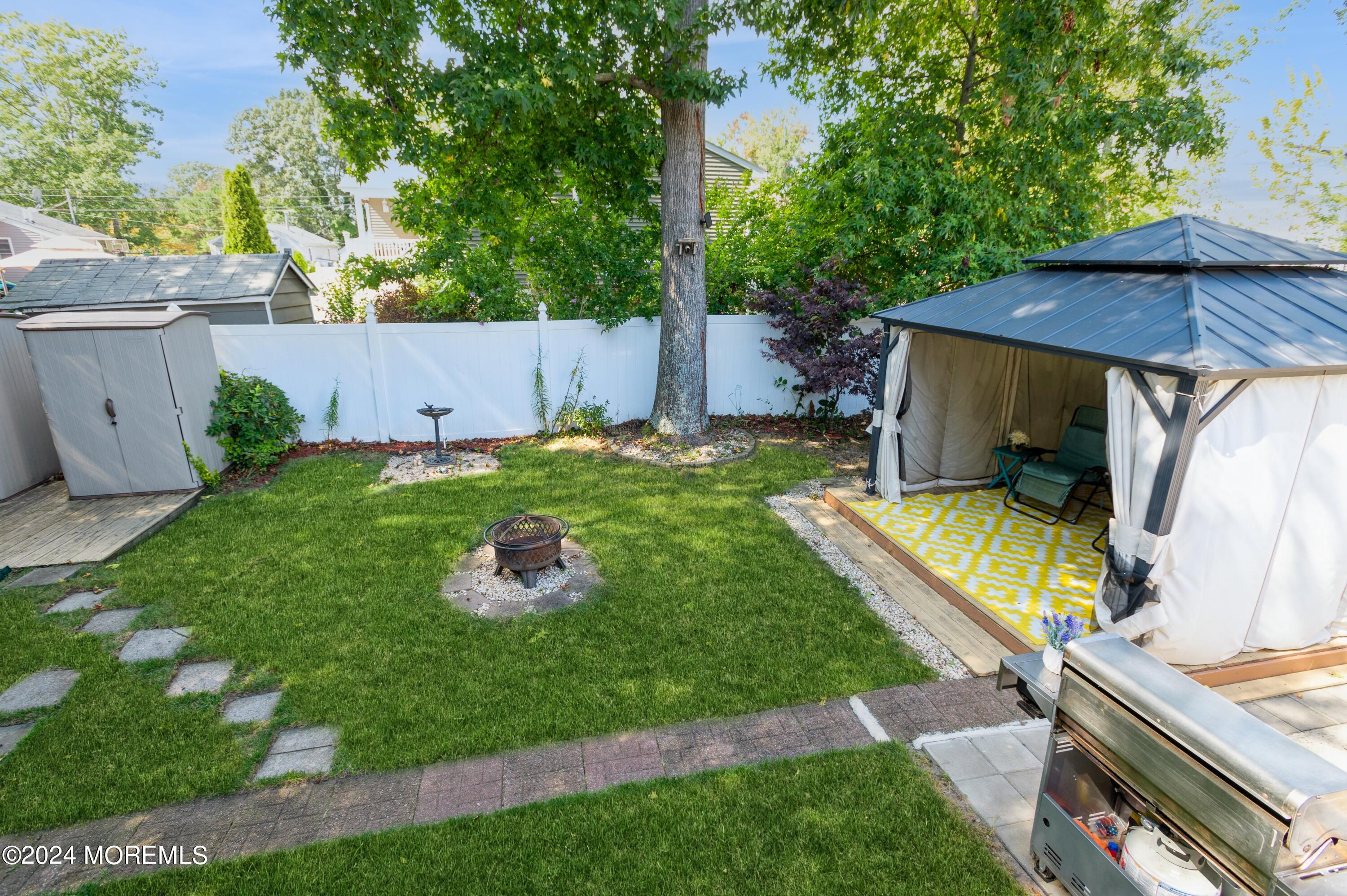62 Capri Drive Brick, NJ 08723 - Photo 20 of 22 a backyard of a house with seating space