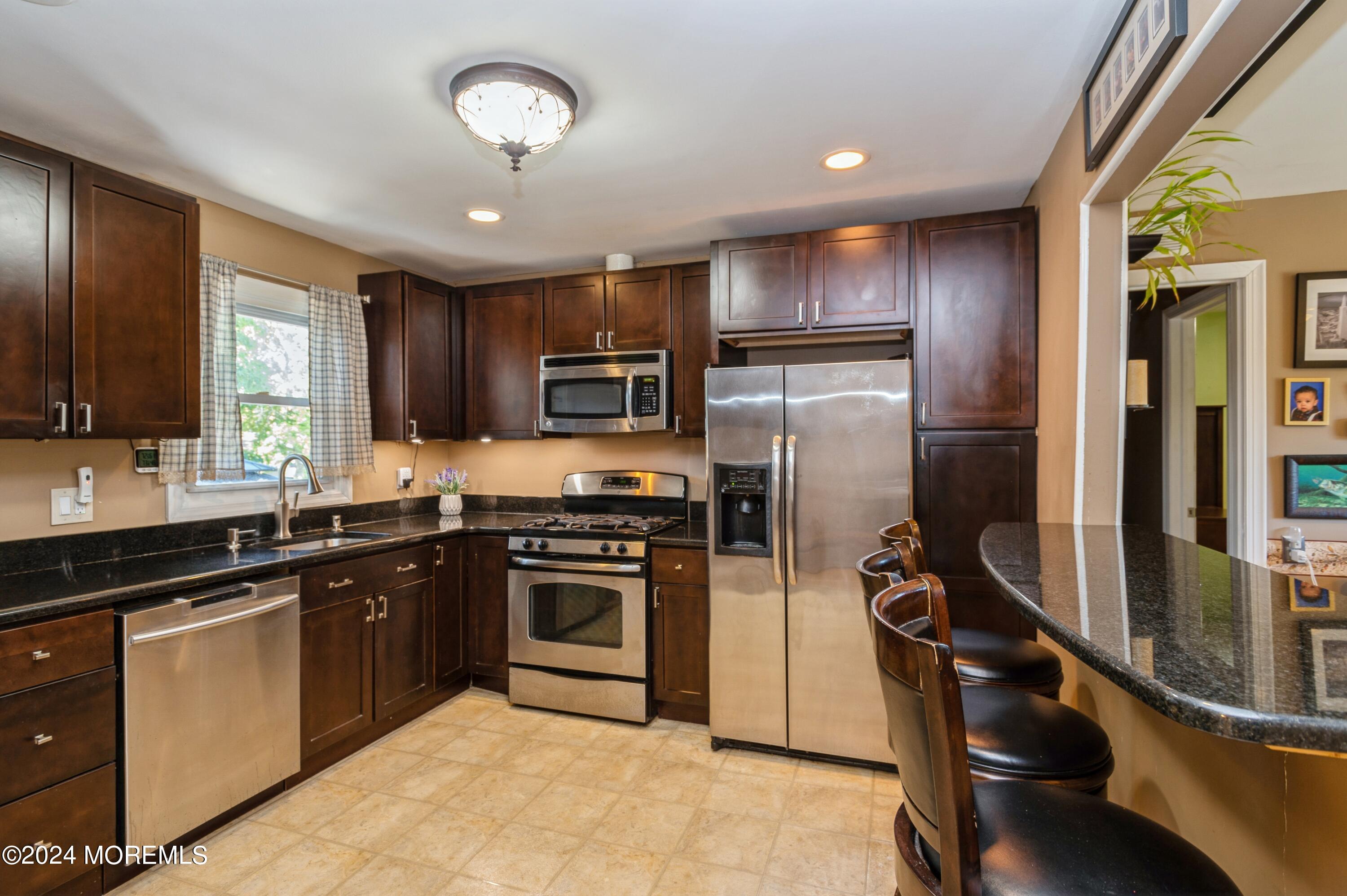 62 Capri Drive Brick, NJ 08723 - Photo 10 of 22 a kitchen with refrigerator cabinets and furniture