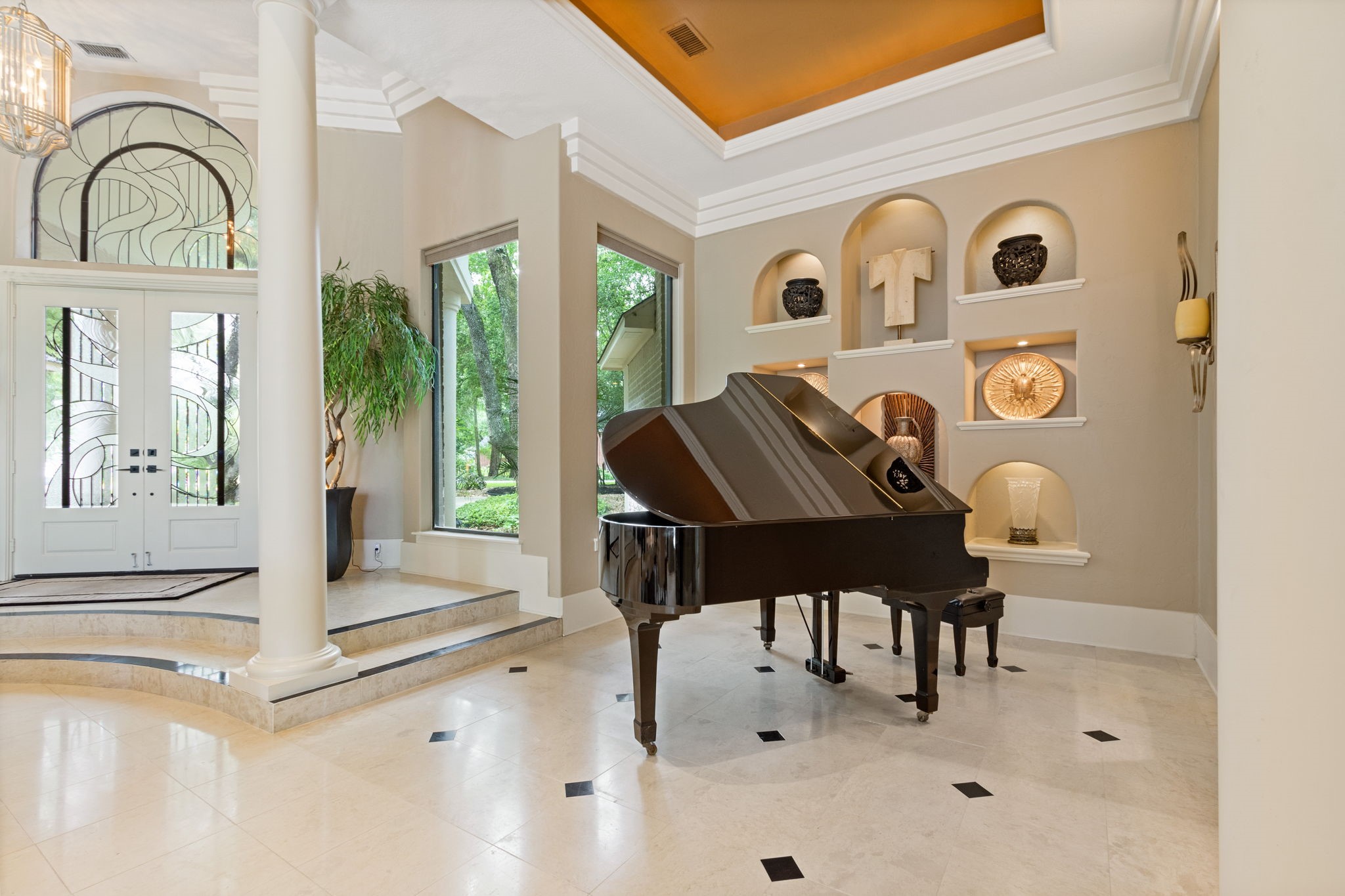 17511 Seidel Road Tomball, TX 77377 - Photo 13 of 49 This elegant living space features high ceilings, and large windows that offer ample natural light. The entryway showcases decorative glass doors and an artistic alcove wall, creating a sophisticated ambiance.