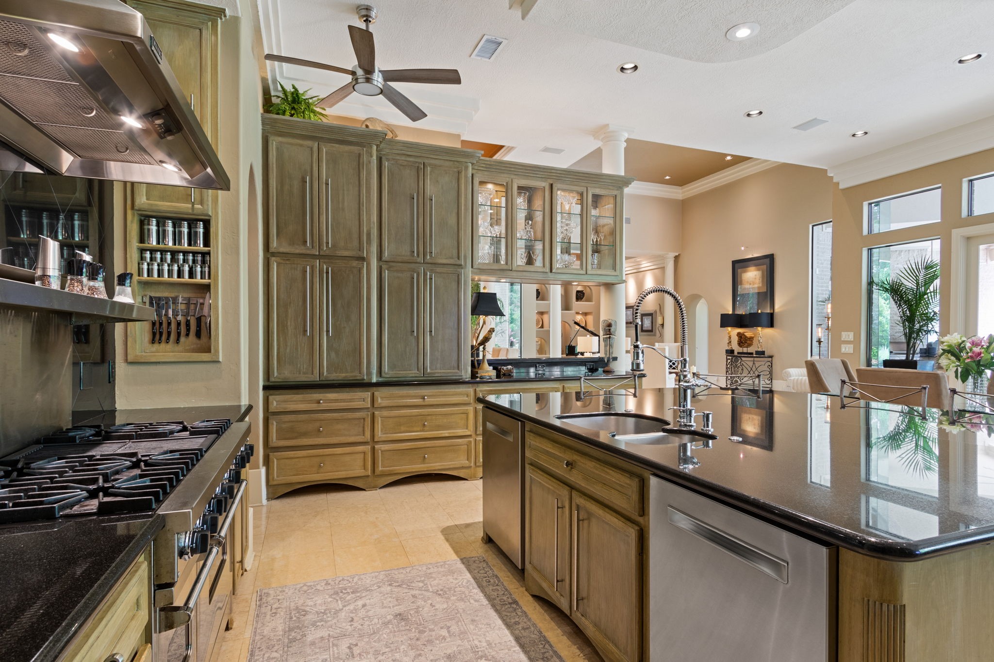 17511 Seidel Road Tomball, TX 77377 - Photo 20 of 49 This spacious kitchen features elegant White oak cabinetry, a large island with granite countertops, and lighted cabinets to display your dishes. Beyond the main kitchen, the home offers 4 additional food prep areas: the baker's room, main utility/office area, summer kitchen, & flex room of the garage., all thoughtfully designed for large scape entertaining.