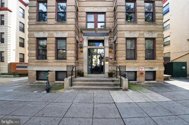 a view of a brick building with many windows