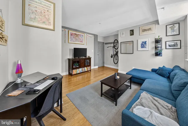 a living room with furniture a flat screen tv and a dining table