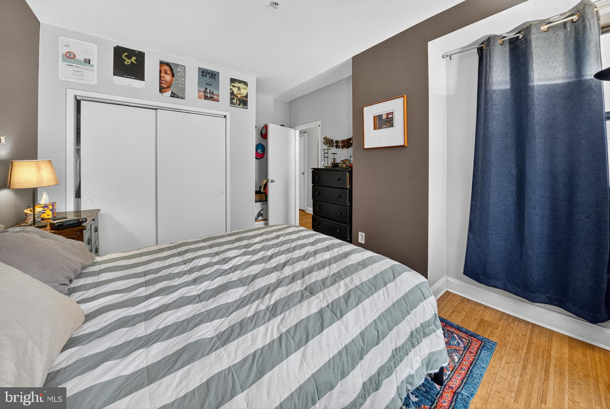 1440 W Street Northwest, Unit 304 Washington, DC 20009 - Photo 10 of 15 a bedroom with a bed and a lamp