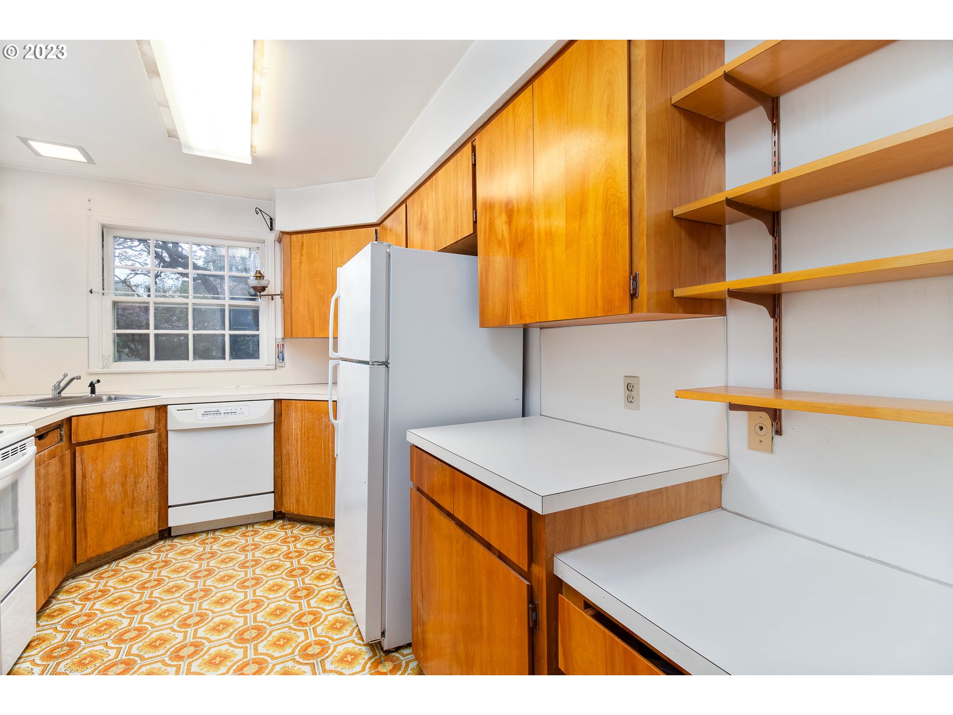 7343 North Foss Avenue Portland, OR 97203 - Photo 11 of 39 a kitchen with stainless steel appliances a refrigerator and a stove top oven
