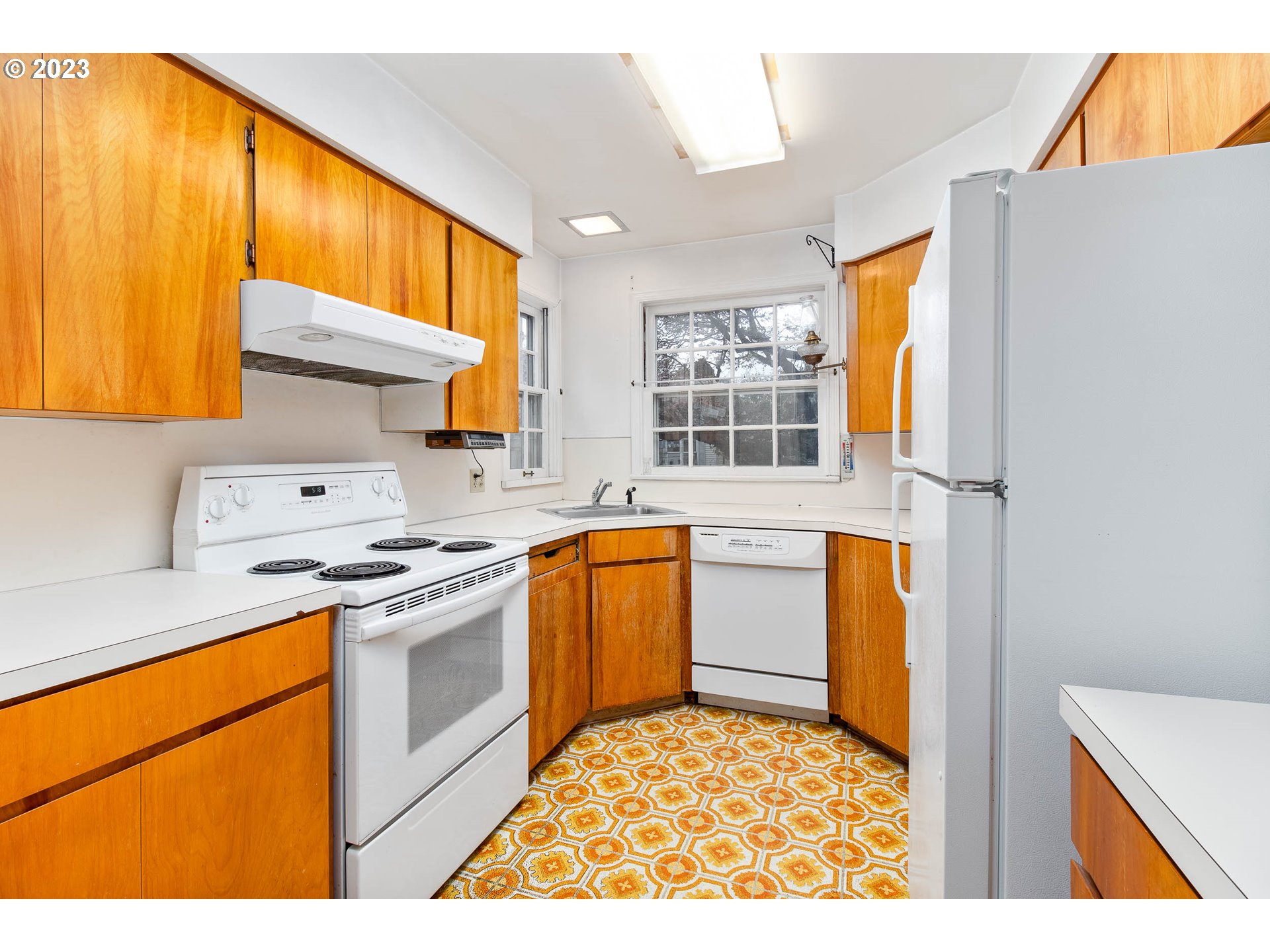 7343 North Foss Avenue Portland, OR 97203 - Photo 12 of 39 a kitchen with stainless steel appliances granite countertop a stove a sink and a refrigerator
