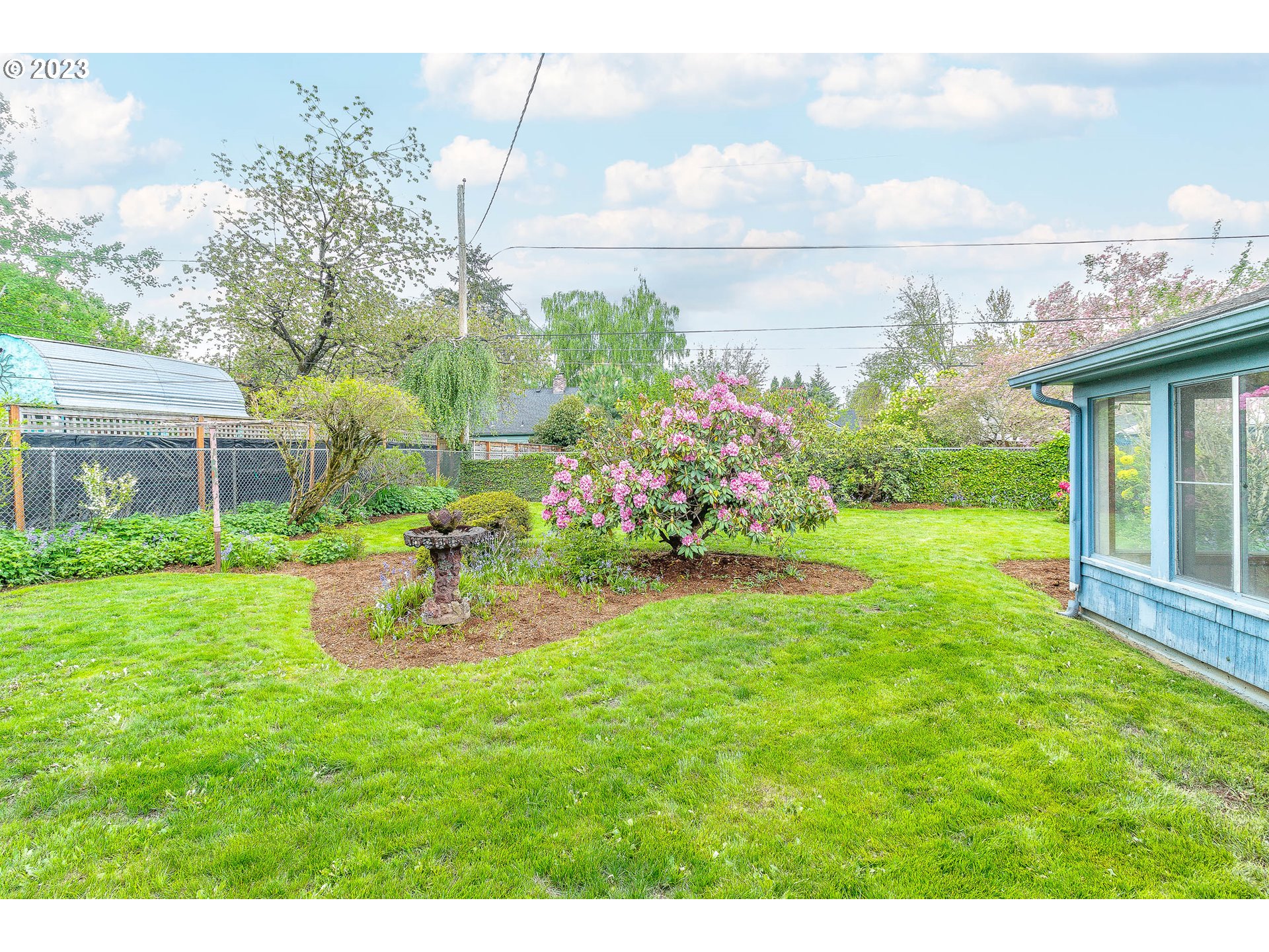 7343 North Foss Avenue Portland, OR 97203 - Photo 31 of 39 a view of a house with backyard sitting area and garden