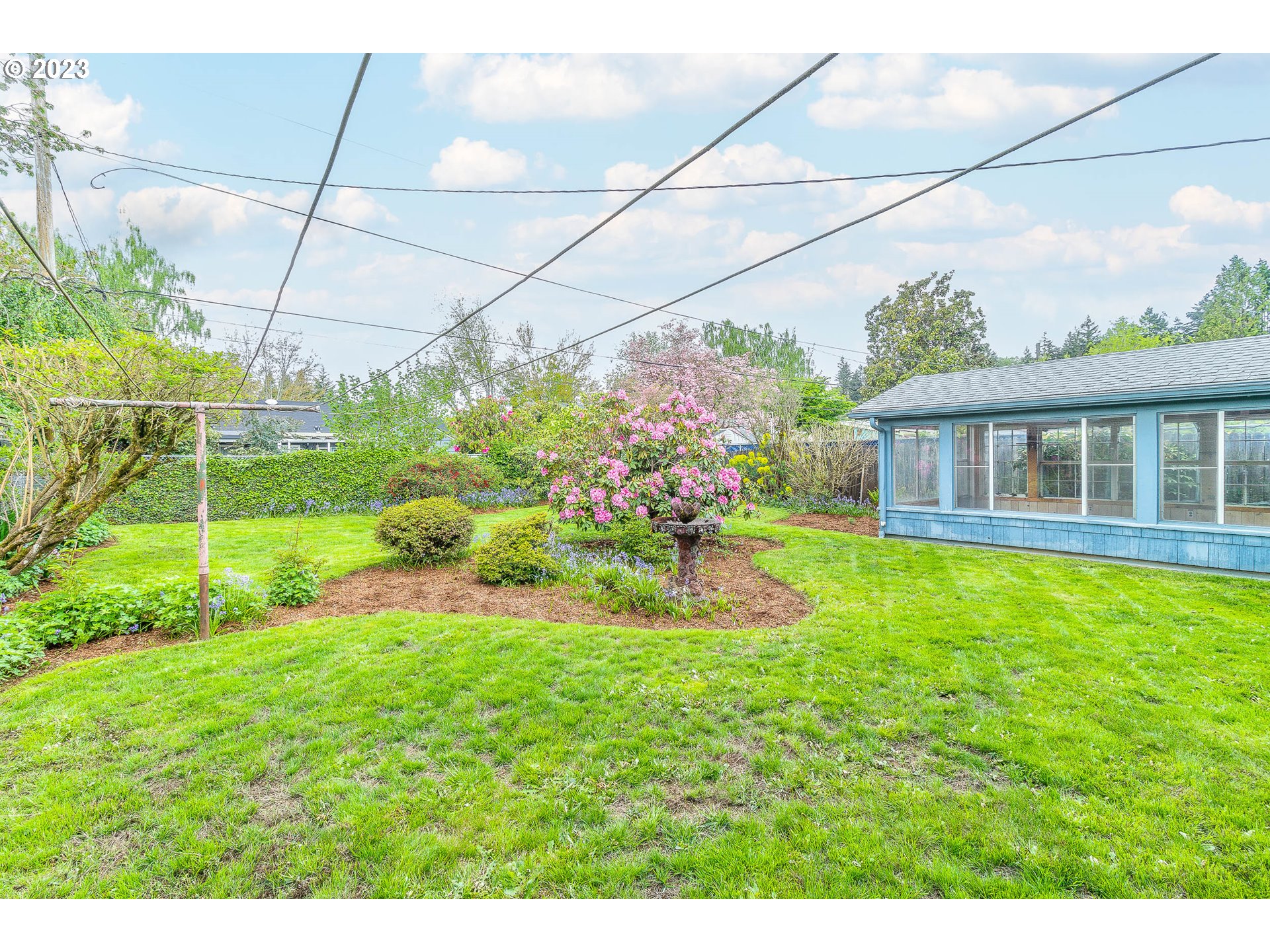 7343 North Foss Avenue Portland, OR 97203 - Photo 32 of 39 a view of a house with a backyard and a garden