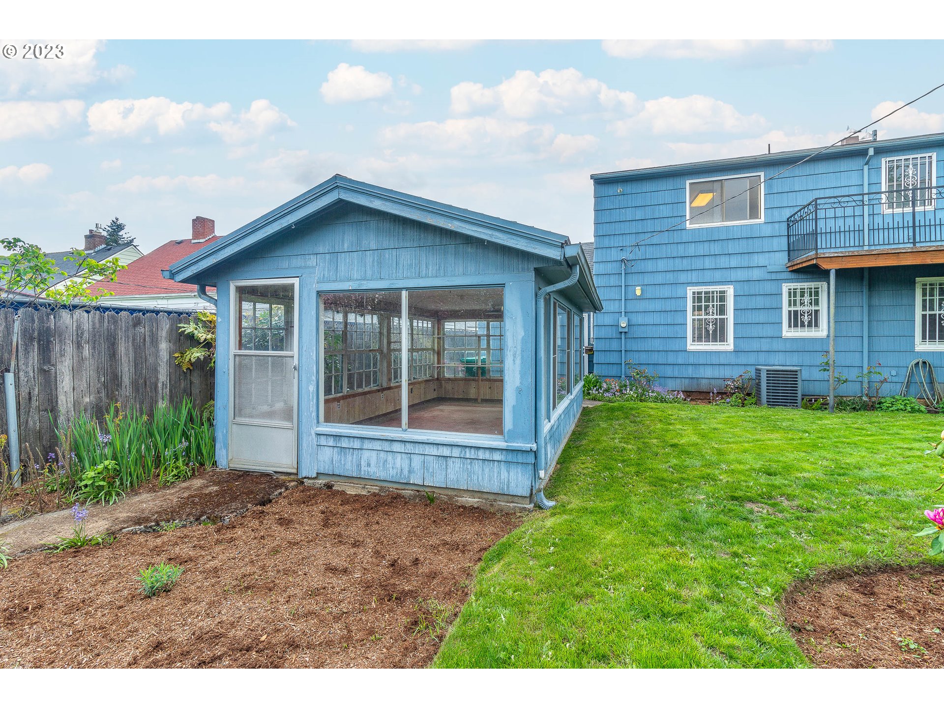 7343 North Foss Avenue Portland, OR 97203 - Photo 36 of 39 a view of brick house with a yard and plants