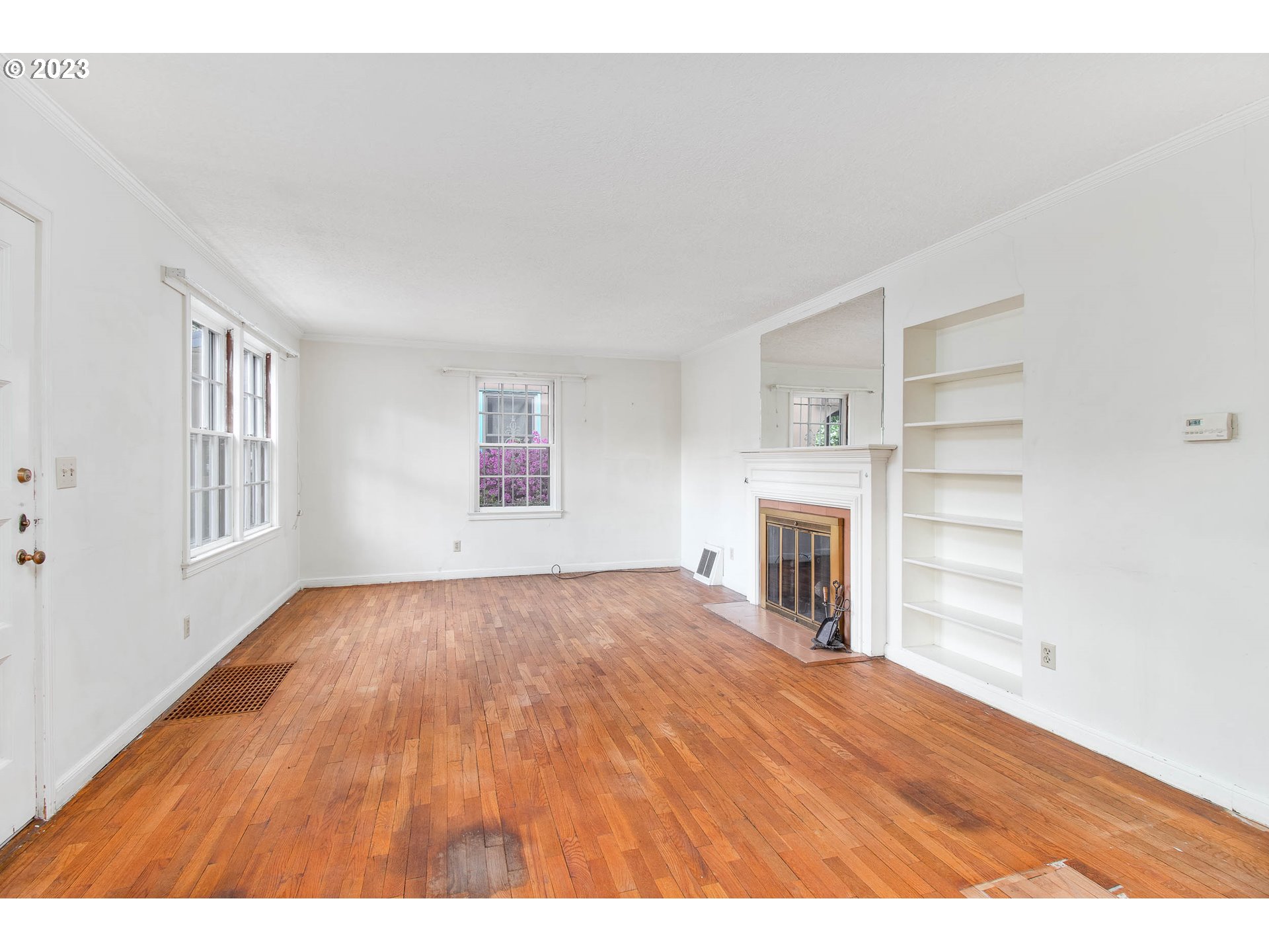 7343 North Foss Avenue Portland, OR 97203 - Photo 5 of 39 a view of empty room with a fireplace and wooden floor