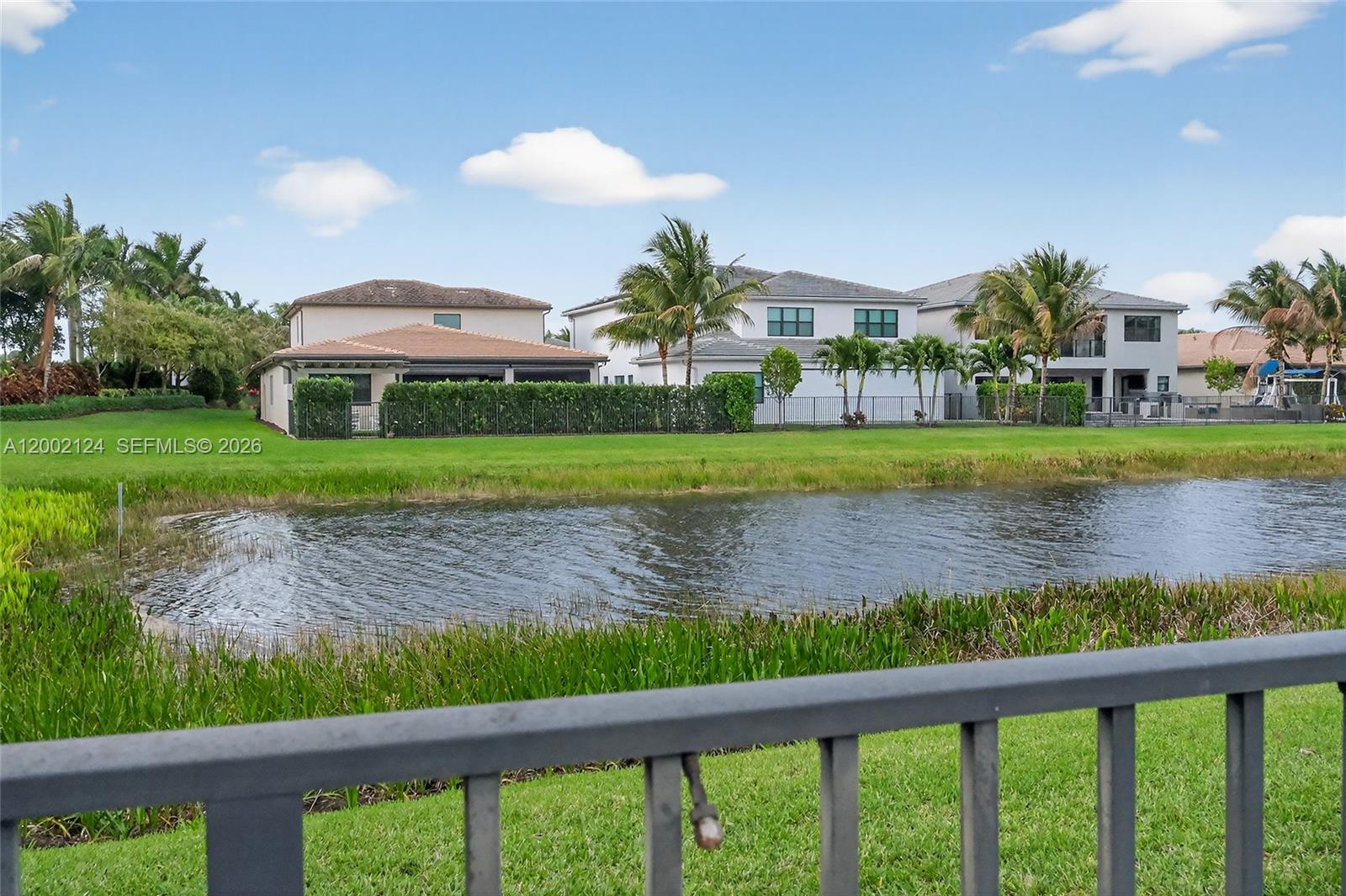 8871 New River Falls Road Boca Raton, FL 33496 - Photo 38 of 47 a front view of a house with a yard and a garden