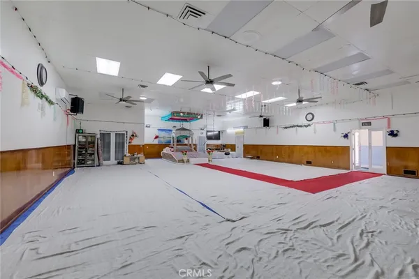 a room with lots of furniture and a chandelier