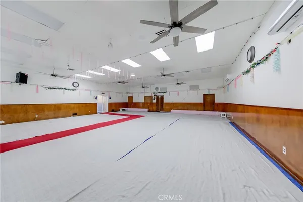 a living room with lots of furniture and a ceiling fan