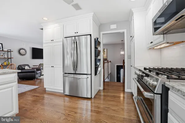 a kitchen with stainless steel appliances a refrigerator stove and microwave
