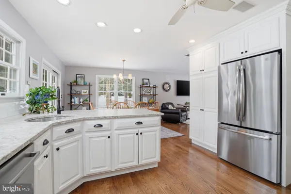 a kitchen with granite countertop a refrigerator and a sink