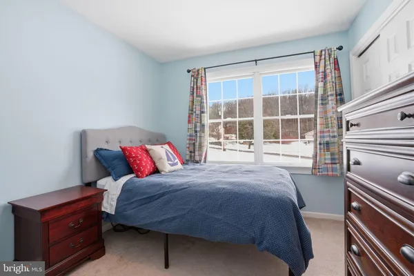 a bedroom with a bed and a large window
