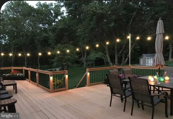 a view of a dinning table and chairs in patio of the house