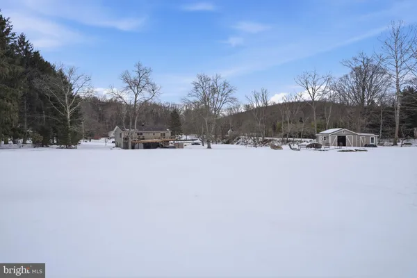 a view of a white house with a yard