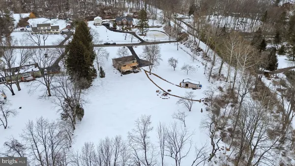 an aerial view of a house with swimming pool table and chairs