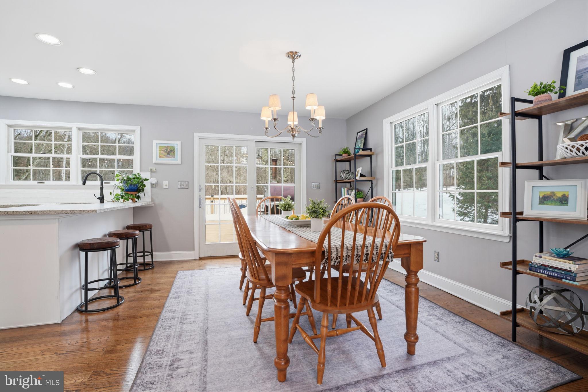 521 Cokesbury Road Annandale, NJ 08801 - Photo 9 of 56 a dining room with furniture a chandelier and wooden floor
