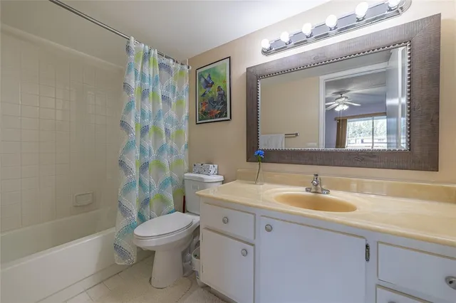 a bathroom with a sink toilet a mirror and shower