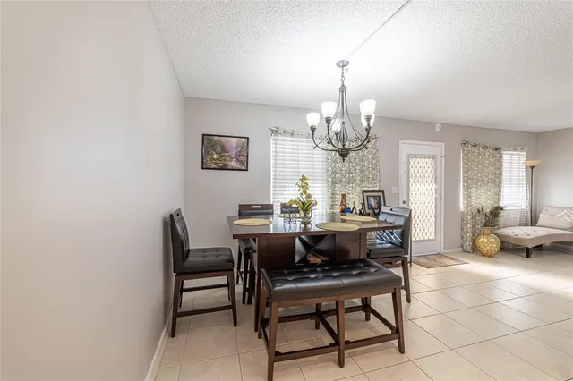 a view of a dining room with furniture and chandelier