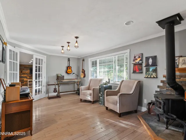 a large bedroom with a bed and wooden floor