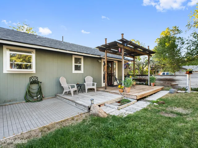 a front view of a house with a yard table and chairs