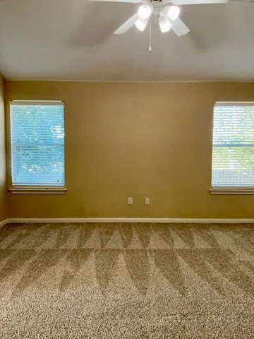 an empty room with windows and closet