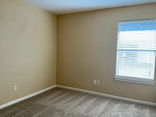 an empty room with wooden floor and closet