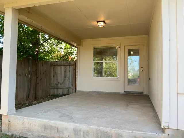 a view of a backyard with a small cabin and a chair