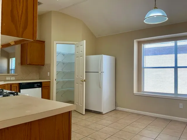 a kitchen with stainless steel appliances a refrigerator and a stove