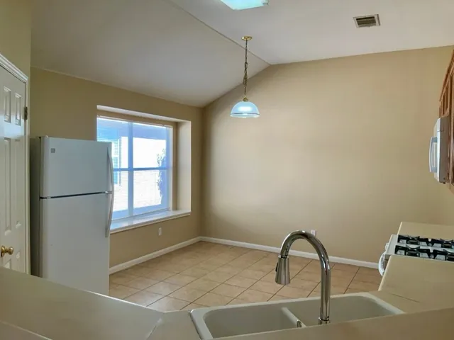 a view of an empty room with exposed radiator and fireplace