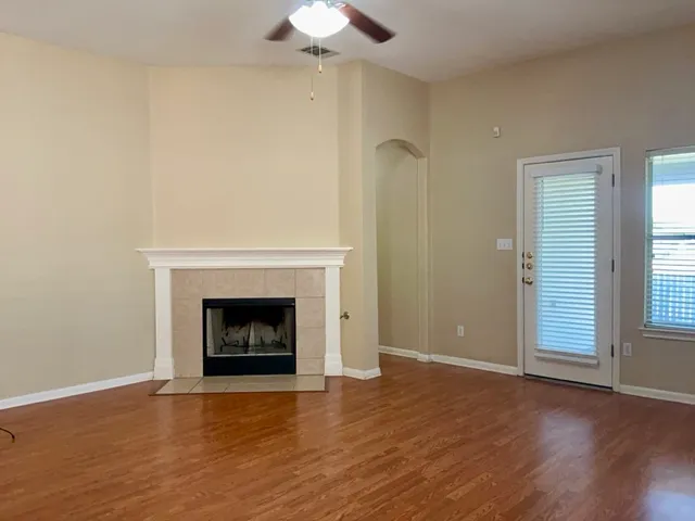 wooden floor in an empty room with a fireplace