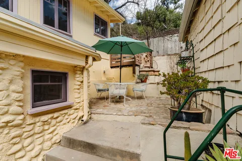 a view of a chairs and table in the patio