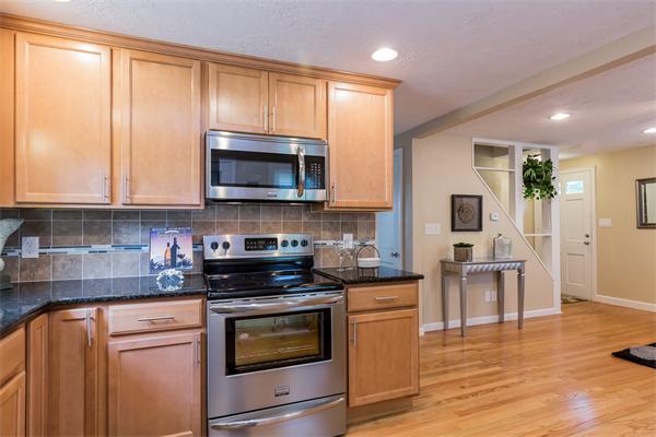 104 Roy Street Springfield, MA 01104 - Photo 13 of 30 a kitchen with a stove a microwave and cabinets