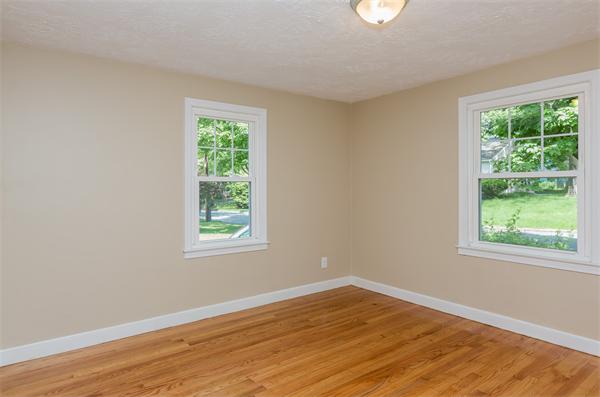 104 Roy Street Springfield, MA 01104 - Photo 16 of 30 a view of an empty room with wooden floor and a window