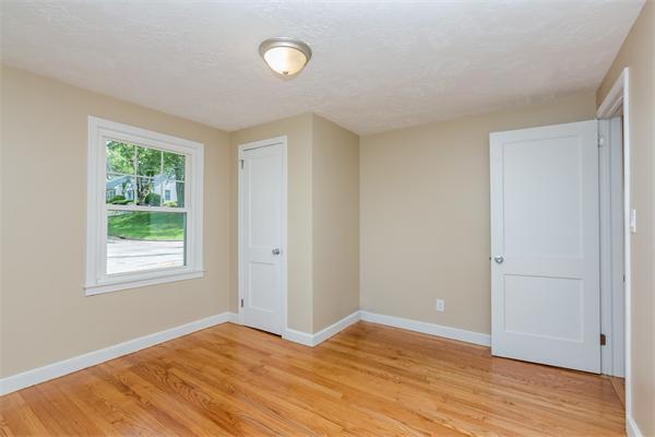 104 Roy Street Springfield, MA 01104 - Photo 17 of 30 a view of an empty room with wooden floor and a window