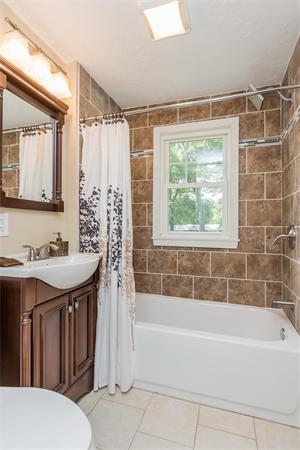 104 Roy Street Springfield, MA 01104 - Photo 18 of 30 a bathroom with a tub sink and mirror