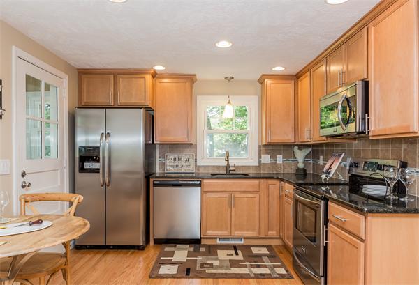 104 Roy Street Springfield, MA 01104 - Photo 2 of 30 a kitchen with granite countertop a sink stainless steel appliances and cabinets