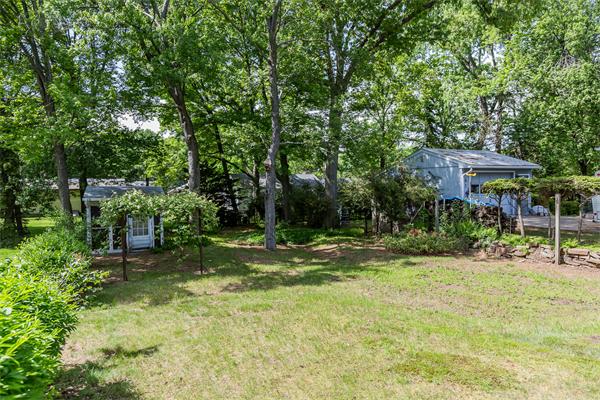 104 Roy Street Springfield, MA 01104 - Photo 5 of 30 a view of a backyard with a table and chairs under an umbrella