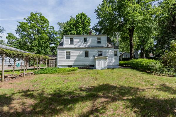 104 Roy Street Springfield, MA 01104 - Photo 6 of 30 a front view of a house with a garden and tree