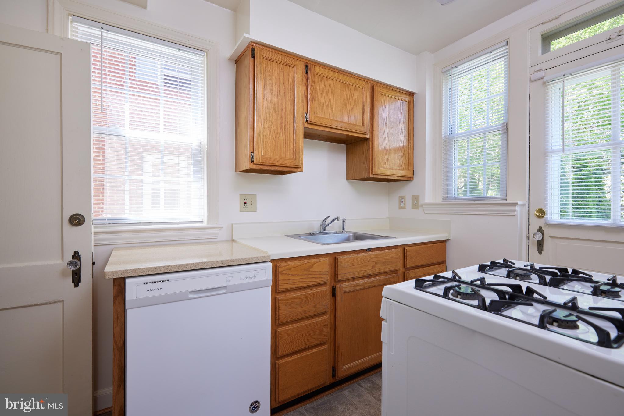3501 Alton Place Northwest Washington, DC 20008 - Photo 11 of 29 a kitchen with a sink stove top oven and cabinets