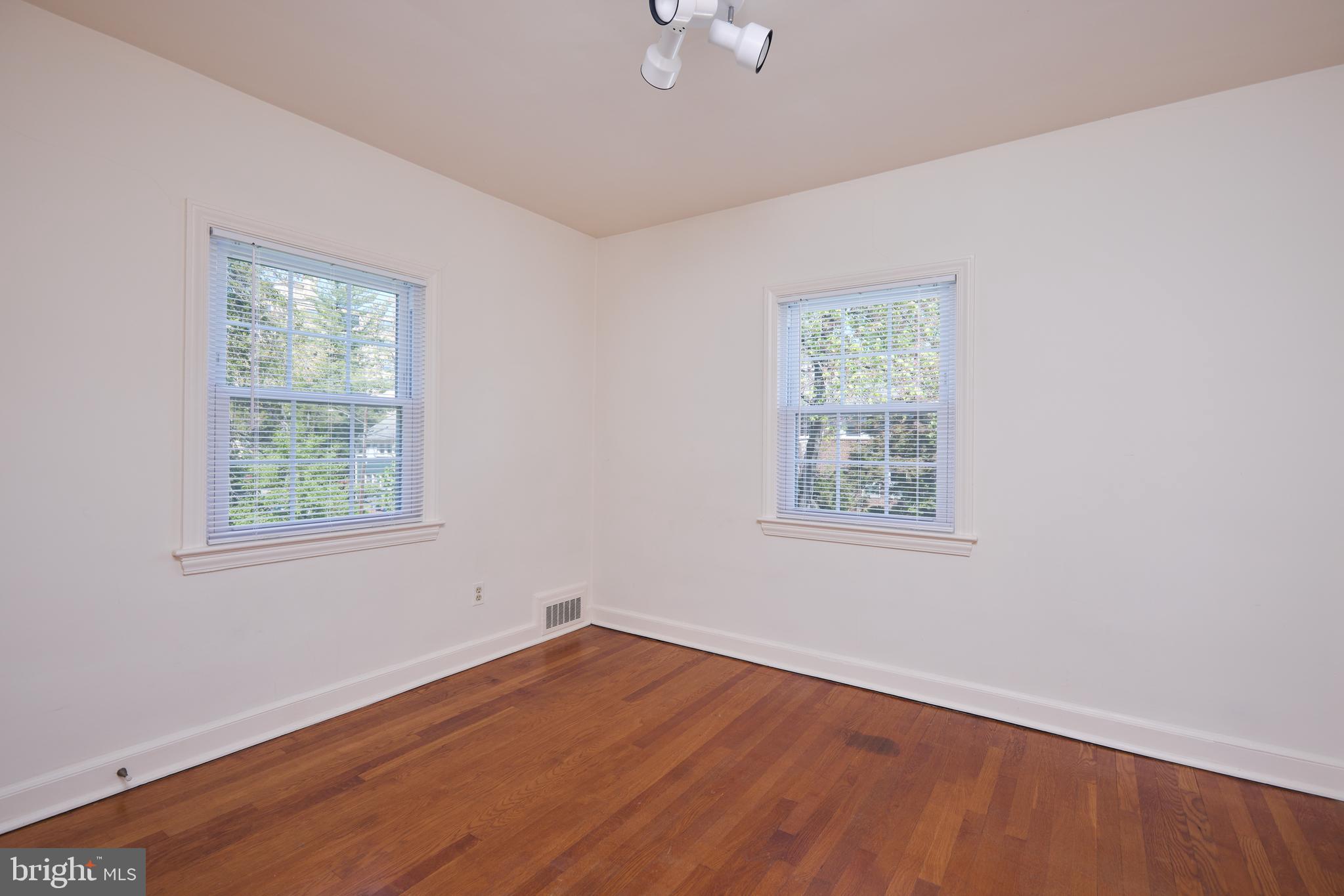 3501 Alton Place Northwest Washington, DC 20008 - Photo 16 of 29 a view of an empty room with wooden floor and a window