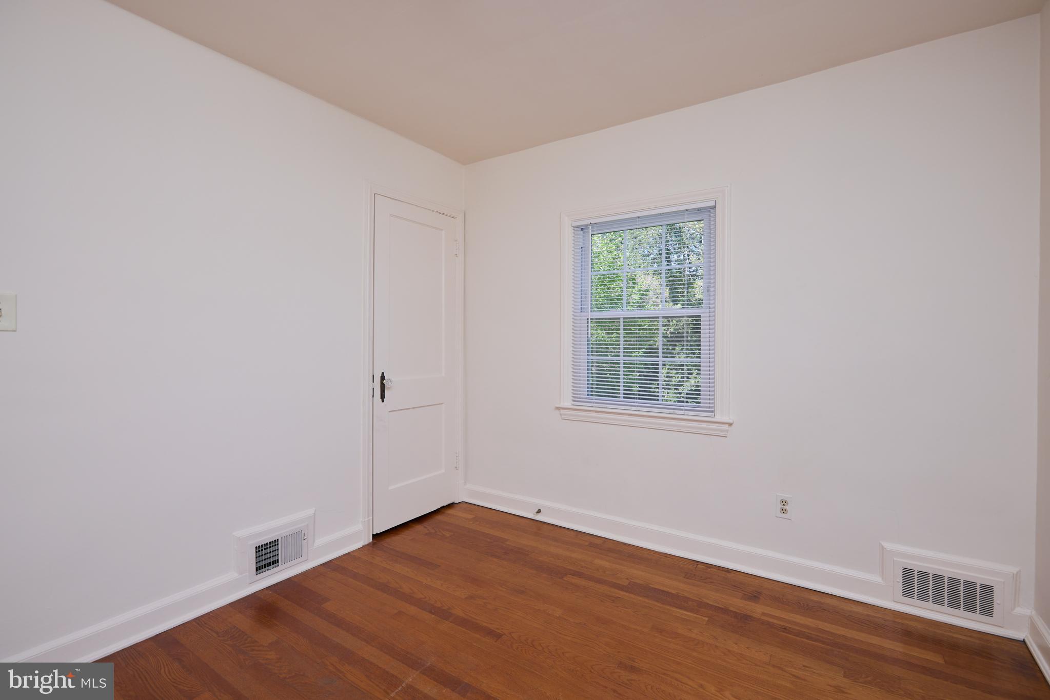 3501 Alton Place Northwest Washington, DC 20008 - Photo 17 of 29 a view of an empty room with wooden floor and a window