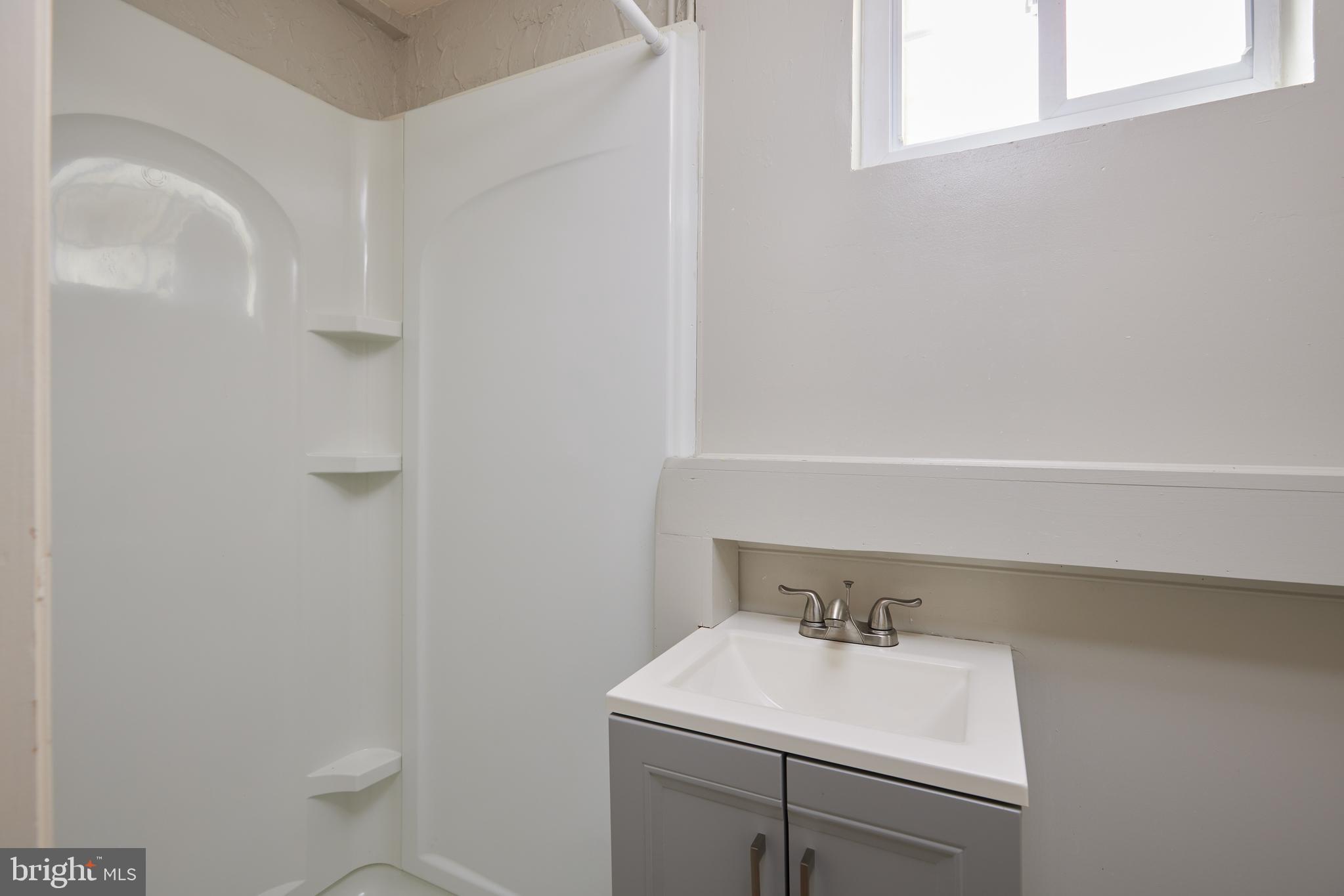 3501 Alton Place Northwest Washington, DC 20008 - Photo 23 of 29 a bathroom with a sink a toilet and a window